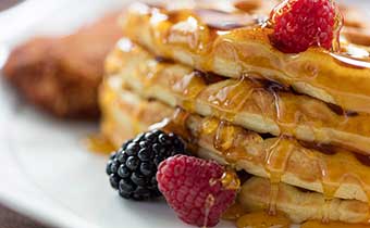 Waffles with berries and syrup